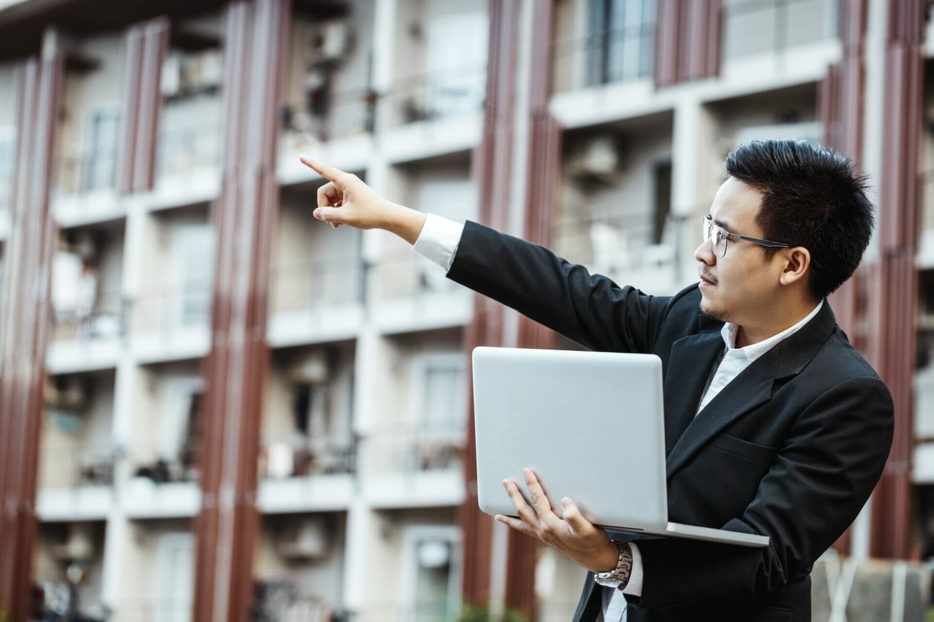 Business Concept - Young Business man plan project on his property with laptop